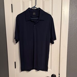 Men’s size Medium Oakley brand polo in deep navy blue.